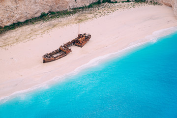 An old rusted ship, wrecked, lies on the seashore. Navagio Bay Shipwreck Beach Greece, Zakynthos