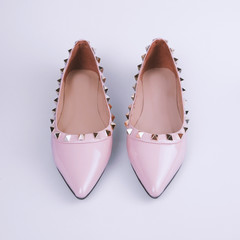 Female pink shoes on gray background