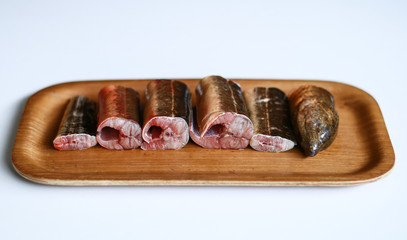 Pieces of eel ready to cook on white background.
