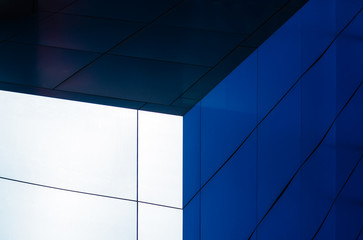 fragment of the wall of a modern blue building on a white background