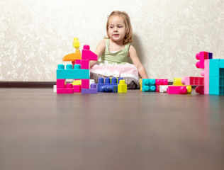 The child plays in the constructor. the child builds from the designer figures of animals and robots