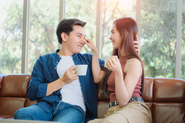 Couple with coffee at bedroom