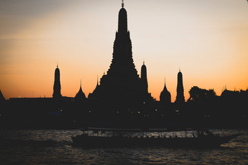 Sunset silhouette scene at Wat Arun Temple. The best place to watch sunset in Bangkok . Wat Arun Temple of the Dawn at sunset on banks of Chao Phraya River Bangkok Thailand Southeast Asia Asia