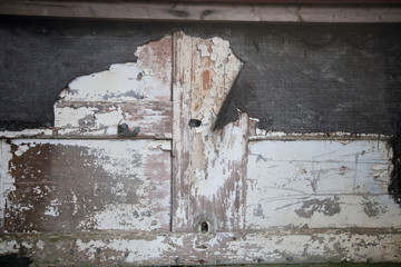 Weathered timber door with peeling paint