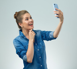 Smiling woman doing selfie with smartphone.
