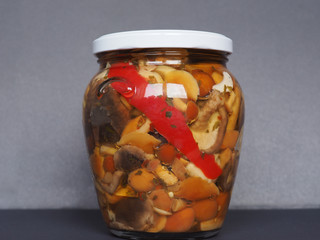 mixed champignons and porcini mushrooms in jar