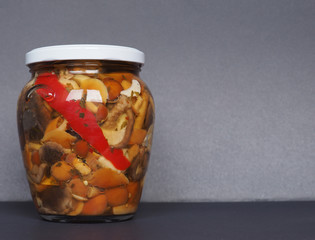 mixed champignons and porcini mushrooms in jar