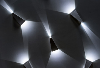 Triangular LED lamps with a white glow. LED lighting in the interior.