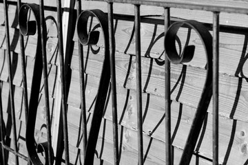 silhouettes of steel on wooden fence