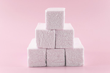 Sweet pink marshmallow rectangular shape in the form of a geometric shape. Marshmallows with the taste of cranberries, strawberries or other berries