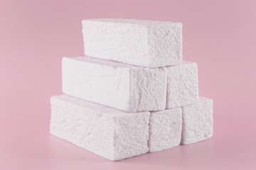 Sweet pink marshmallow rectangular shape in the form of a geometric shape. Marshmallows with the taste of cranberries, strawberries or other berries
