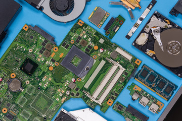 Parts of a modern computer. The insides of a laptop on a blue background, flat lay composition