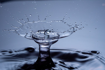 Water drops collision on a blue background. Abstract clear nature background