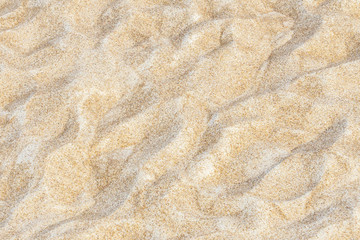 Fototapeta na wymiar Close up of sand pattern background on beach near sea in summer