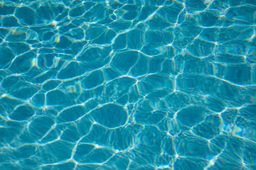 Pattern of blue water surface reflection swimming pool, Ripple wave and motion water for blue background and abstract, Bright and purified azure aquamarine turquoise water with sun reflection in pool