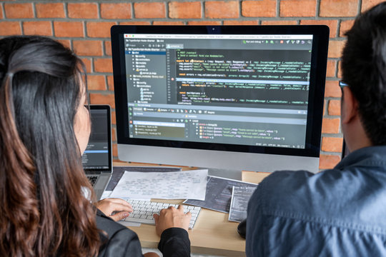 Programmers cooperating at Developing programming and website working in a software develop company office, writing codes and typing data code, Programming with HTML, PHP and javascript