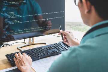 Young Professional programmer working at developing programming and website working in a software...