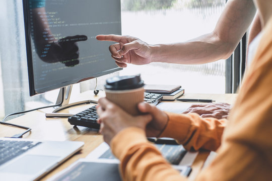 Programmers cooperating at Developing programming and website working in a software develop company office, writing codes and typing data code, Programming with HTML, PHP and javascript
