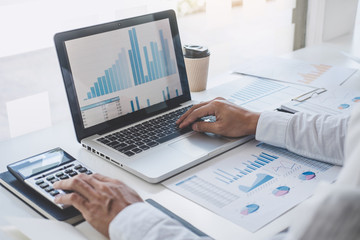 Professional at work, businessman working and analyzing on laptop with calculate statistics of financial document data graph for new project of business strategy and market growth at workplace