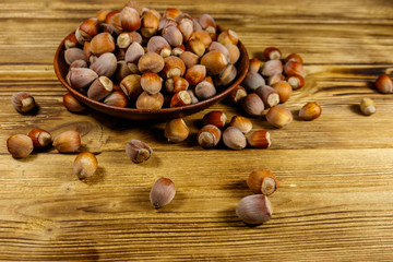 Hazelnuts in ceramic plate on a wooden table