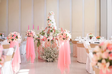 Wedding cake. A beautiful elegance wedding cake decorated with flowers in white and pink theme at a wedding reception.