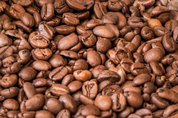 Bunch of tasty delicious roasted coffee beans in coffeeshop. Fresh gourmet flavor aroma. Luxury enjoyment aroma in the morning. Fair trade cafe cappuccino or espresso ingredient for breakfast
