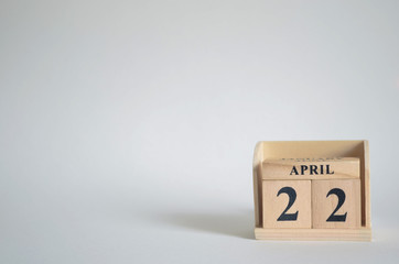 April 22, Empty white background with number cube on the table.