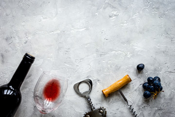 bottle of red wine and corkscrew on stone background top view mockup