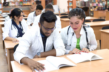 medical university students. A multinational group of young people, while in the classroom, is studying medical literature, taking exams