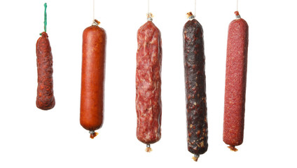 Different hanging sausages isolated on white background