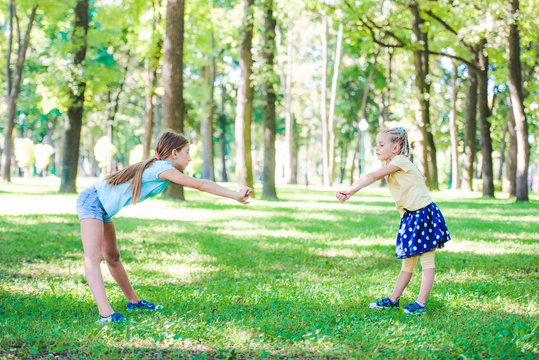 Little Girls Excersise Together In Sunshine Park