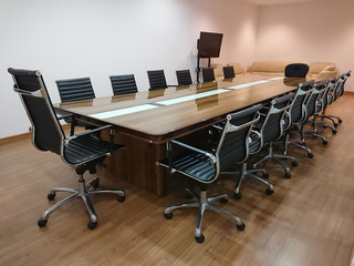 Small meeting room with  Black leather seats.Meeting room professional board room with chairs and table in office