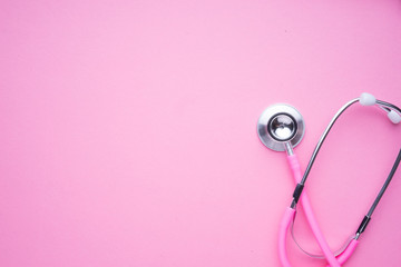 Women in the healthcare industy concept. A pink strethoscope on a pink background.