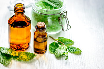 organic cosmetics with herbal extracts of mint on wooden background