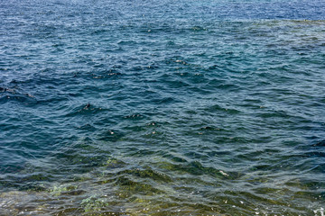 Background shot of aqua sea water surface. Blue sea water in calm.