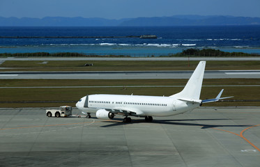 The pure white airplane on the airport