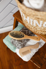 Spa and bath cosmetics, basket with towel rolls in rustic interior. Natural materials in bathroom....