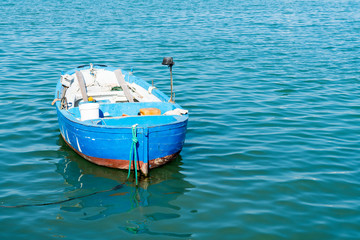 blue wooden fishing boat in the harbour of Molfetta, Italy