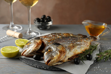 Baked Dorado on garnished wooden background, close up