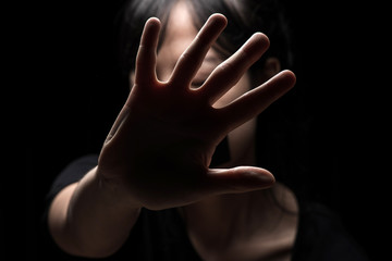 Fototapeta premium International Human Right day Concept: Women with her hand extended signaling to stop