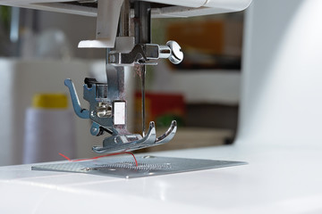 Close-up of sewing machine and sewing needle in fashion design studio