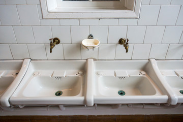 Two white sinks / wash basins in bathroom of disused clinic