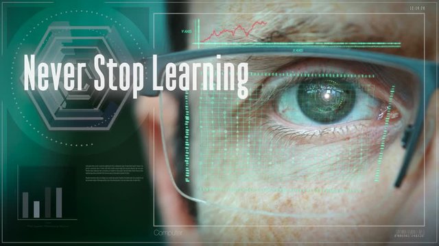 A businessman controlling a futuristic computer screen with a Never Stop Learning Business concept on it.