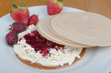 Wafer, traditional Colombian dessert, chopped fruit cookie and sauces
