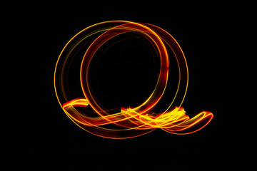 lightpainting effect at night, golden and red colored circle, created with bulb exposure