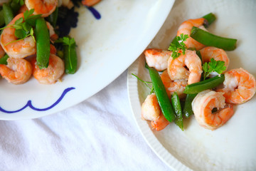 A serving of shrimp and snap peas
