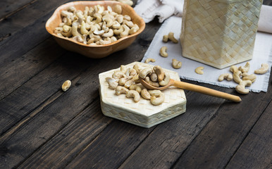 Raw Peeled Cashew Nuts in Wooden Bowl. Organic Cashew with no shell on a dark wooden background
