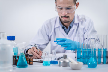 scientist with equipment and science experiments ,laboratory glassware containing chemical liquid for design or decorate science or other your content and selective focus