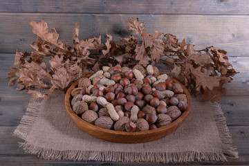 different nuts on a wooden tray.