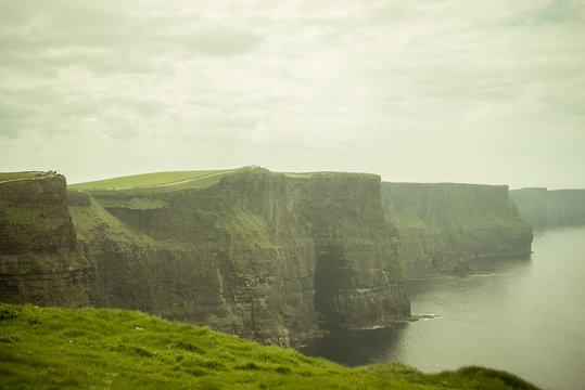 Spectacular views of the famous cliffs of Moher in County Clare, Ireland. A cloudy and foggy day.